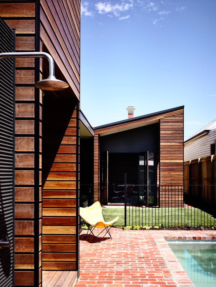 Trendy wood exterior home photo in Melbourne with a shed roof