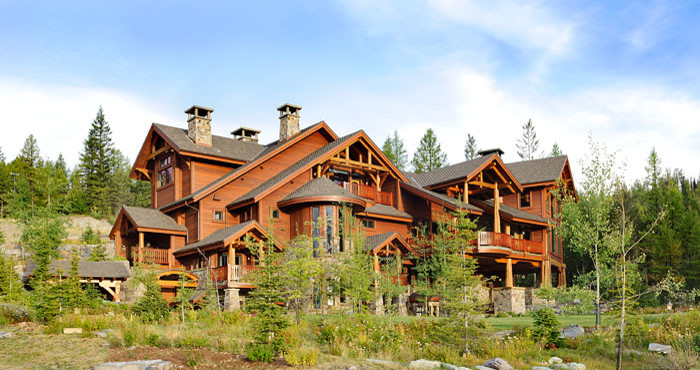 Example of a mountain style brown three-story wood exterior home design in Other