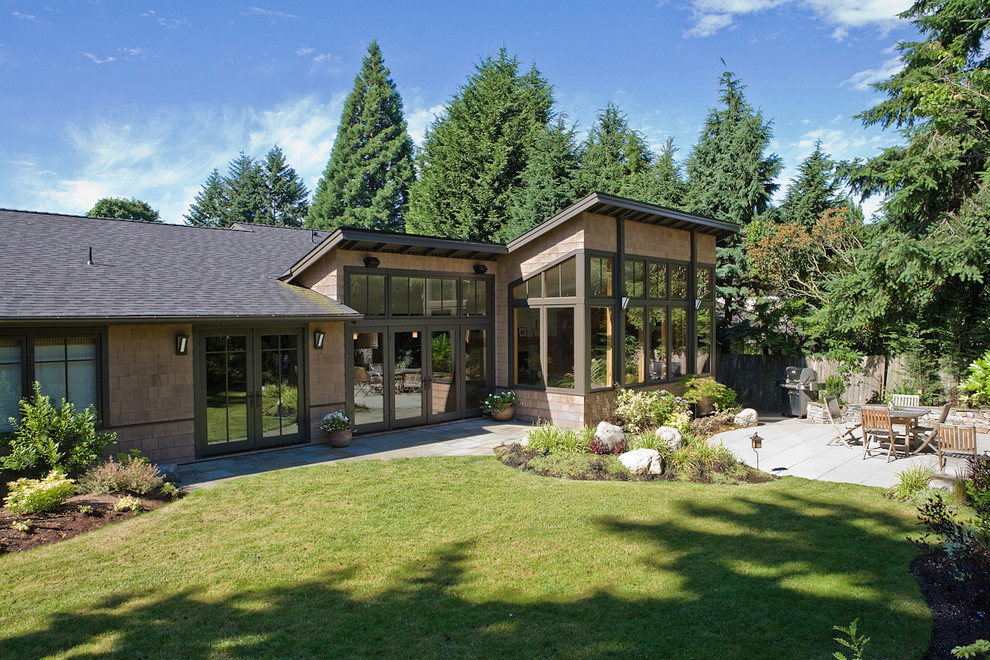 Medium sized contemporary bungalow house exterior in Seattle with wood cladding.