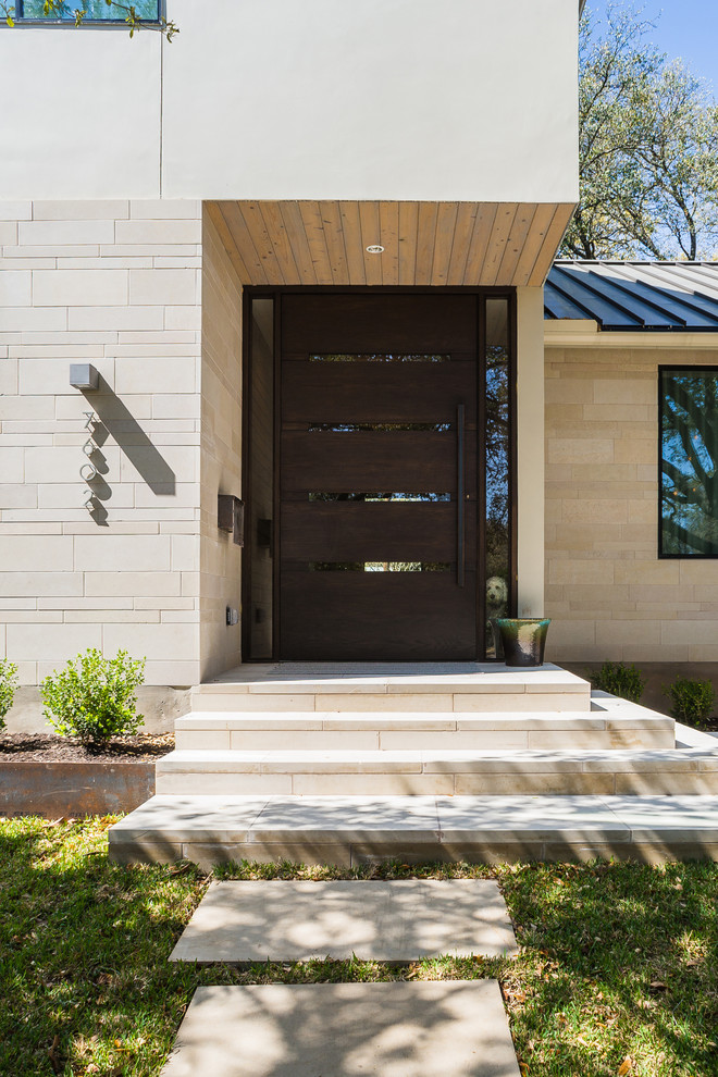 Réalisation d'une façade de maison beige design en béton de plain-pied avec un toit plat.