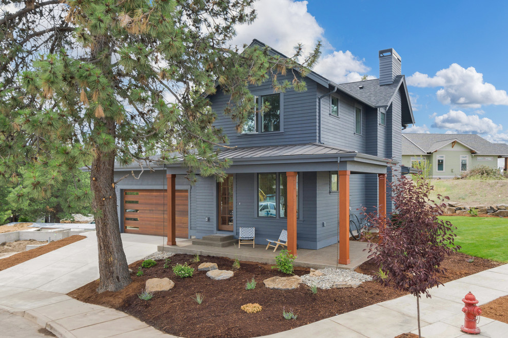 Example of a large minimalist blue two-story exterior home design in Portland with a mixed material roof