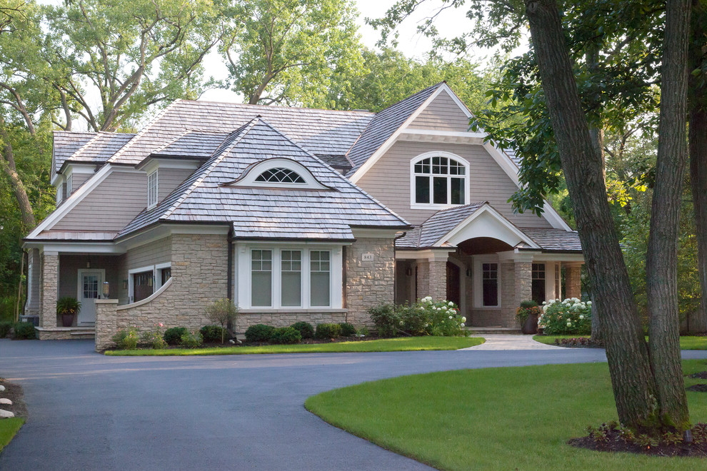 Design ideas for a traditional house exterior in Chicago with wood cladding.