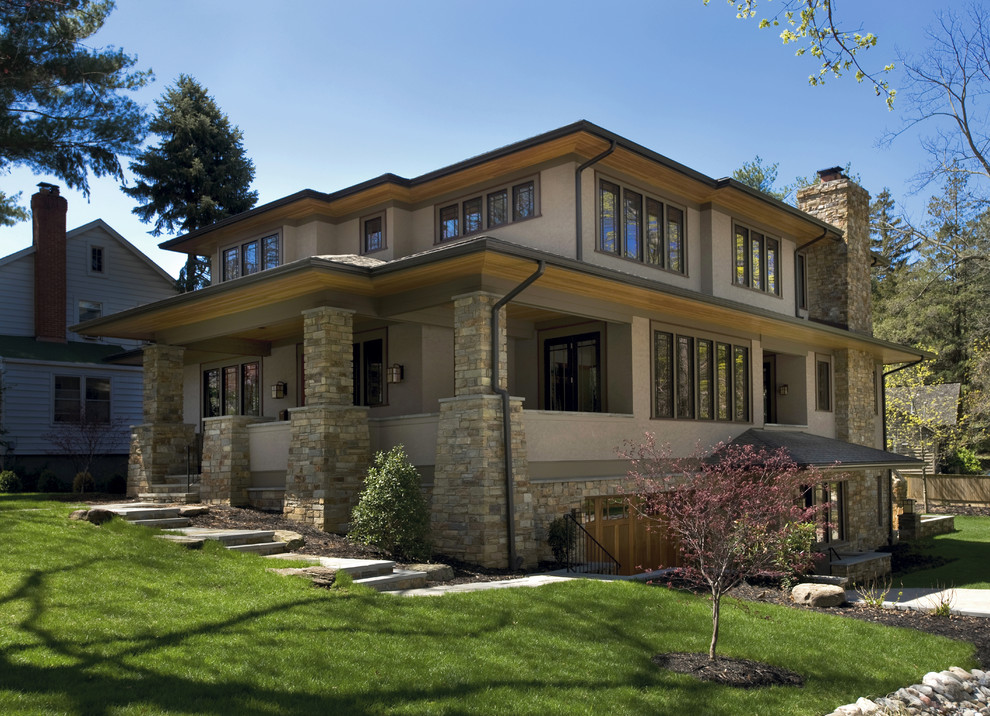 Foto de fachada beige de estilo americano grande de dos plantas con revestimiento de piedra y tejado plano