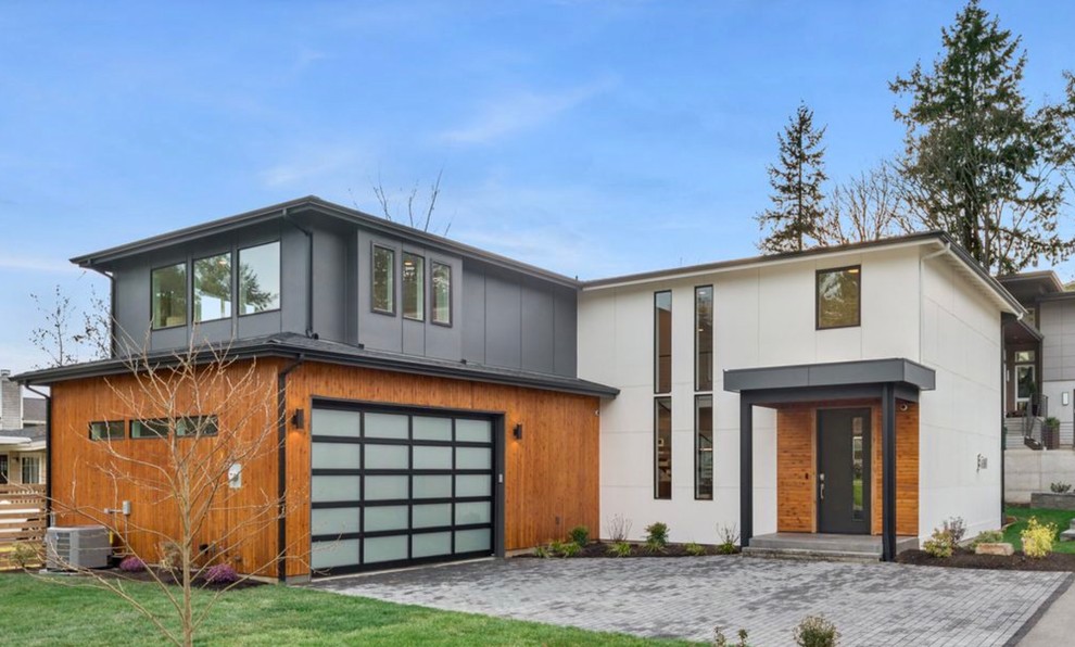 Inspiration for a medium sized and white contemporary two floor detached house in Seattle with concrete fibreboard cladding and a shingle roof.