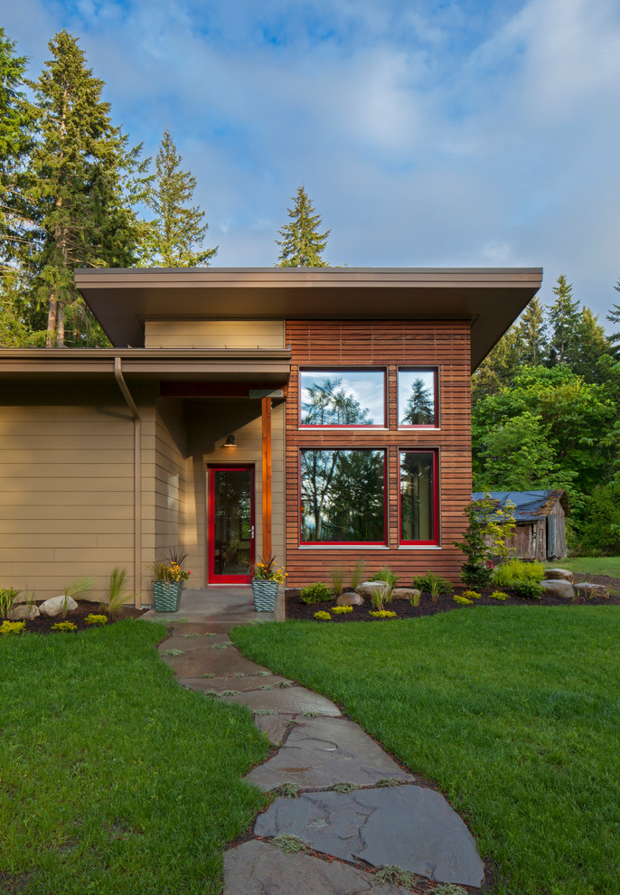 Inspiration for a large contemporary brown one-story wood house exterior remodel in Seattle with a shed roof and a shingle roof