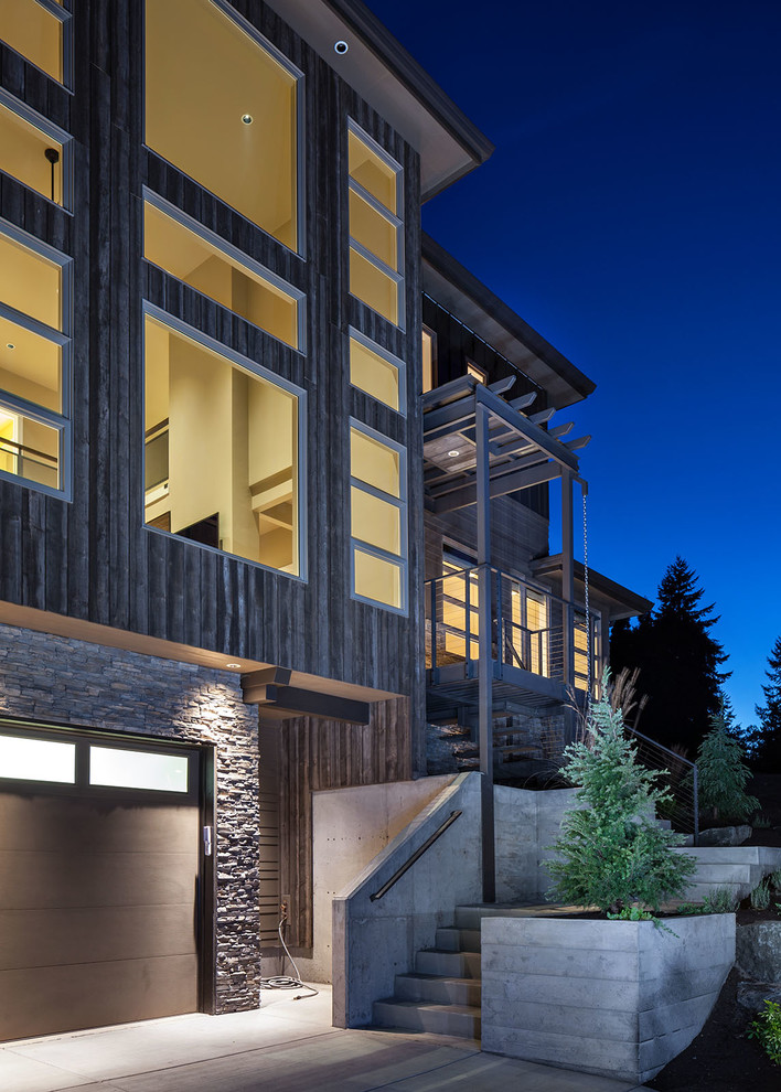 Large contemporary brown three-story wood exterior home idea in Portland with a hip roof