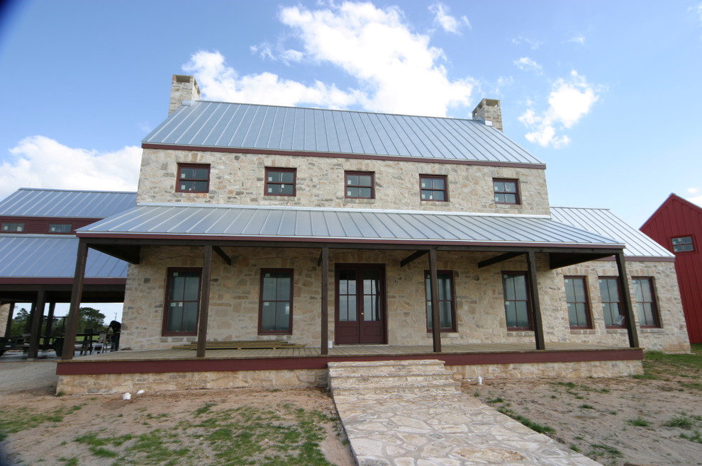 Exempel på ett mycket stort amerikanskt flerfärgat hus, med två våningar, blandad fasad, sadeltak och tak i metall
