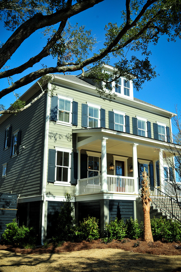Inspiration for a green three-story exterior home remodel in Charleston with a hip roof