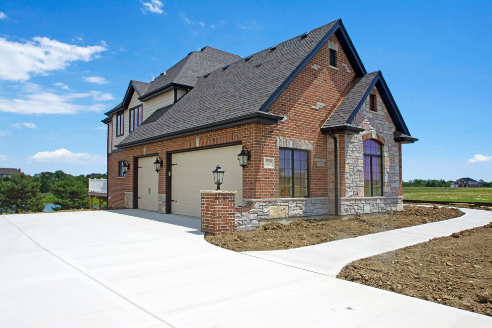 This is an example of a large and red traditional two floor brick detached house in Chicago with a hip roof and a shingle roof.