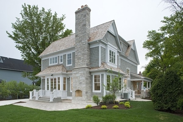Inspiration for a large coastal gray two-story wood gable roof remodel in Chicago