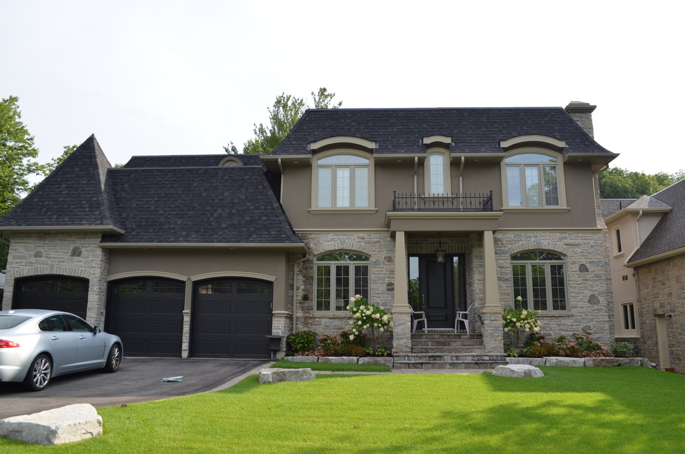 Large and beige midcentury two floor house exterior in Toronto with stone cladding.