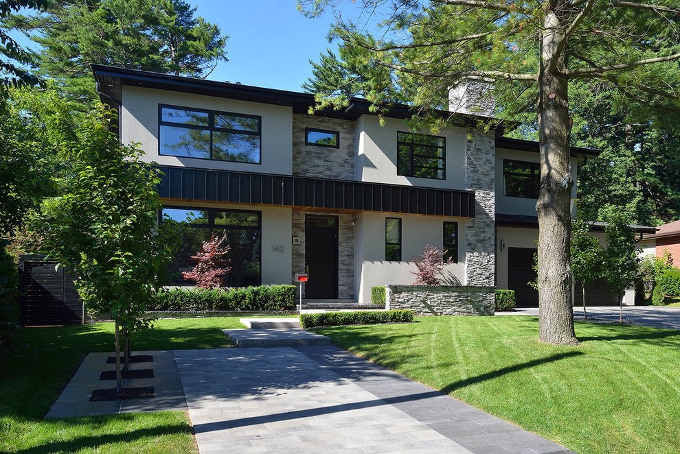 This is an example of a large and white modern two floor render house exterior in Toronto.