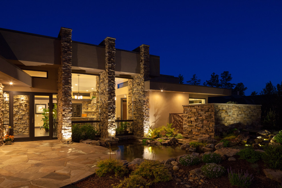 Inspiration for a large contemporary yellow two-story stone exterior home remodel in Charlotte