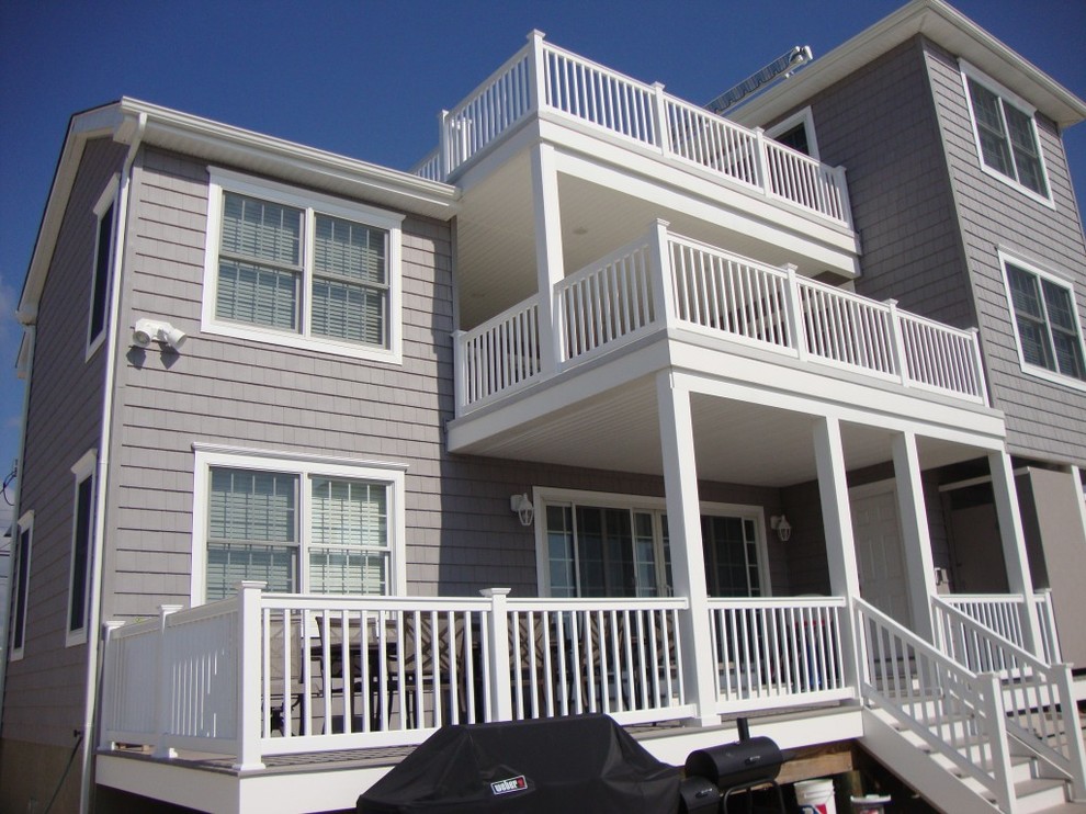 Inspiration for a medium sized and gey coastal house exterior in New York with three floors and vinyl cladding.