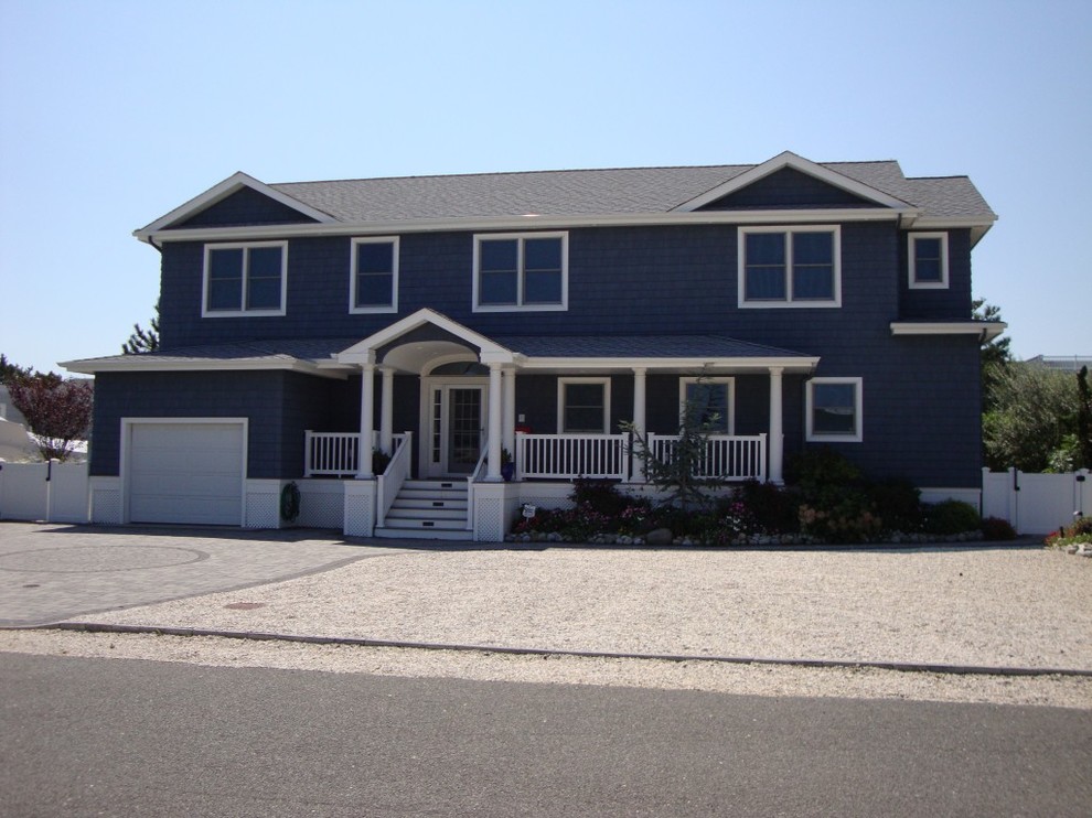 Mid-sized beach style blue two-story vinyl exterior home photo in New York