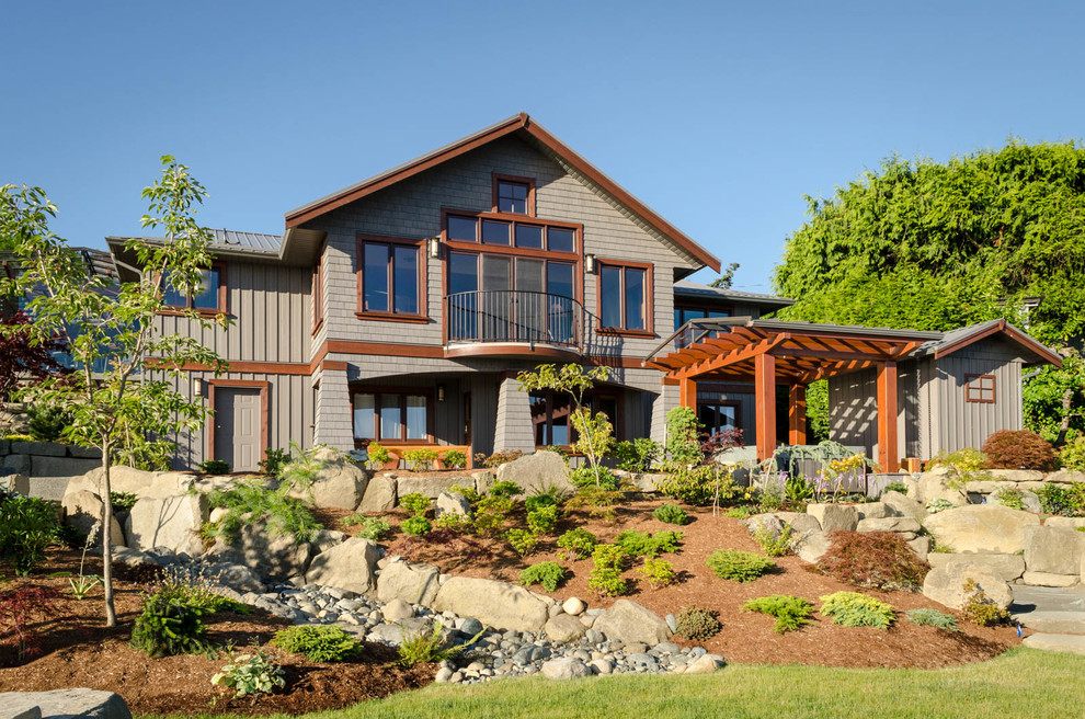 Example of a large arts and crafts brown two-story wood gable roof design in Vancouver