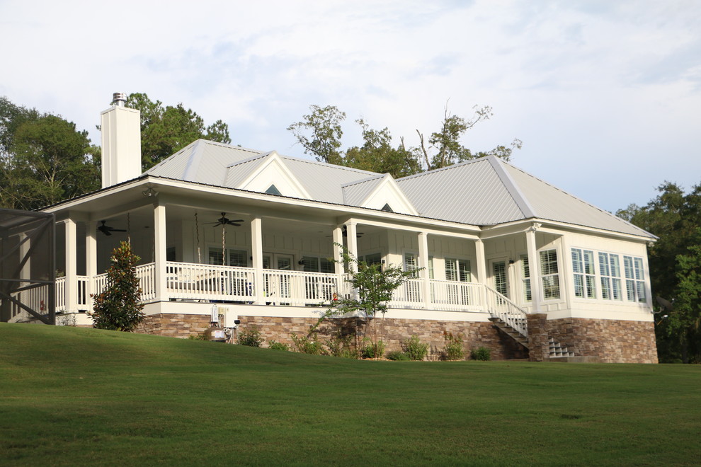 Foto de fachada de casa blanca tropical grande con tejado a cuatro aguas y tejado de metal