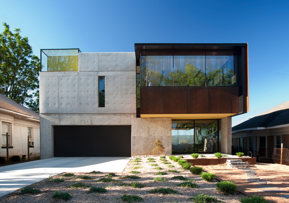 Пример оригинального дизайна: двухэтажный, серый дом в современном стиле с облицовкой из бетона и плоской крышей