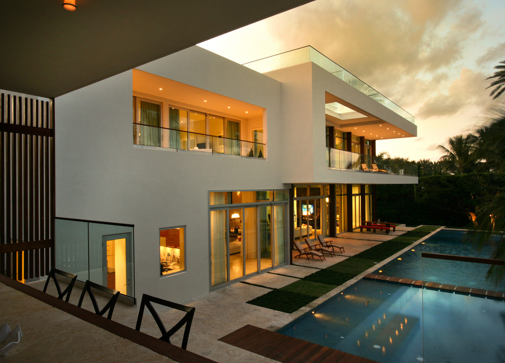 Large contemporary white one-story flat roof idea in Miami