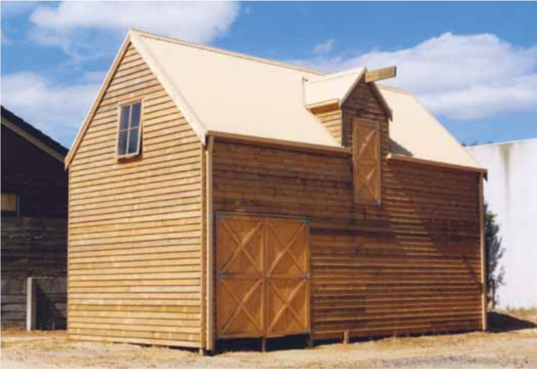 Immagine della villa piccola marrone country a piani sfalsati con rivestimento in legno, tetto a capanna e copertura in metallo o lamiera