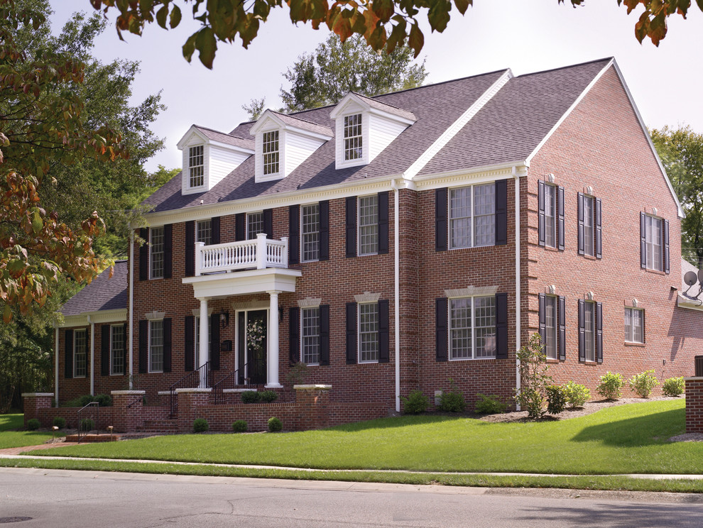 Inspiration for a large timeless red two-story brick exterior home remodel in Other