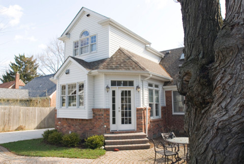 Photo of a medium sized and white traditional two floor house exterior in Detroit with mixed cladding.