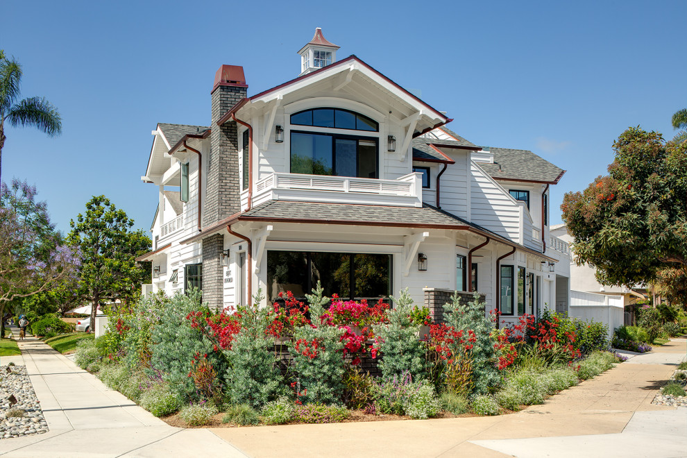 Inspiration for a mid-sized coastal white two-story wood exterior home remodel in San Diego with a shingle roof