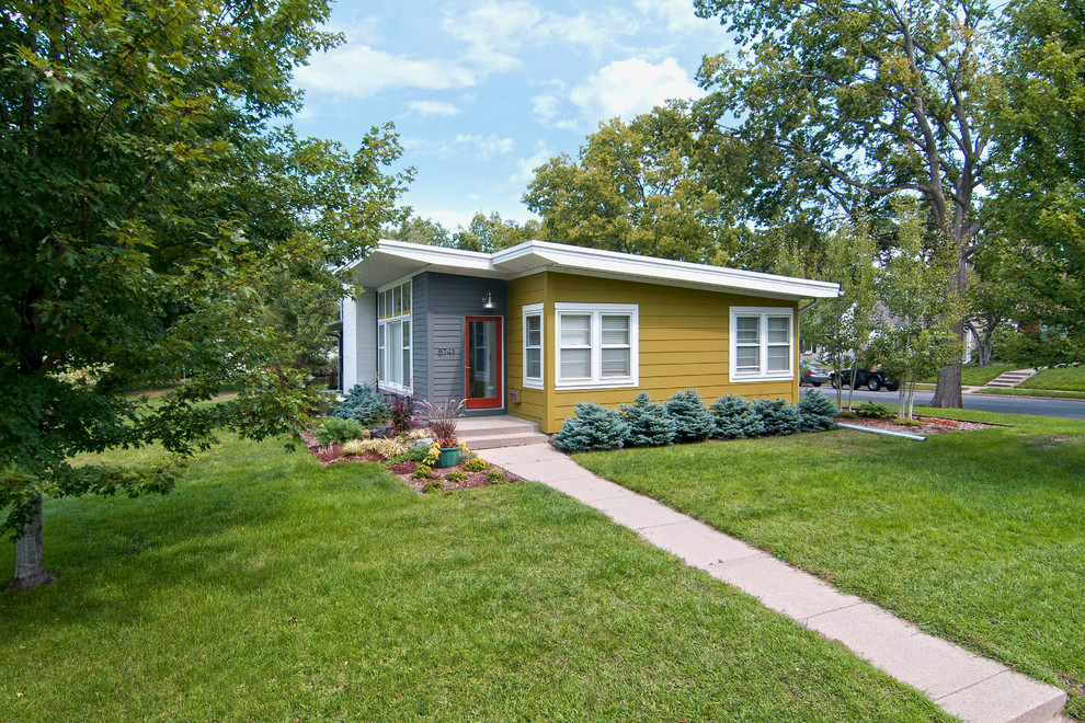 Example of a small 1960s one-story exterior home design in Minneapolis with a shed roof