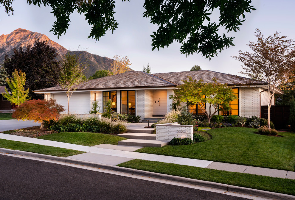 Photo of a medium sized and white classic bungalow brick detached house in Salt Lake City with a hip roof and a shingle roof.