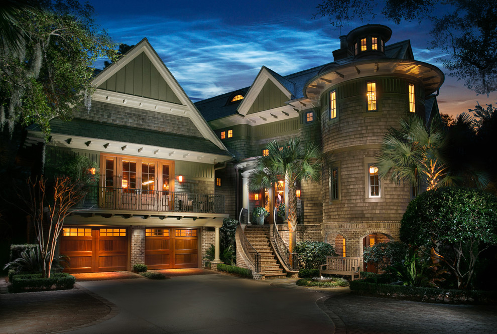 Example of a large island style green two-story mixed siding exterior home design in Charleston