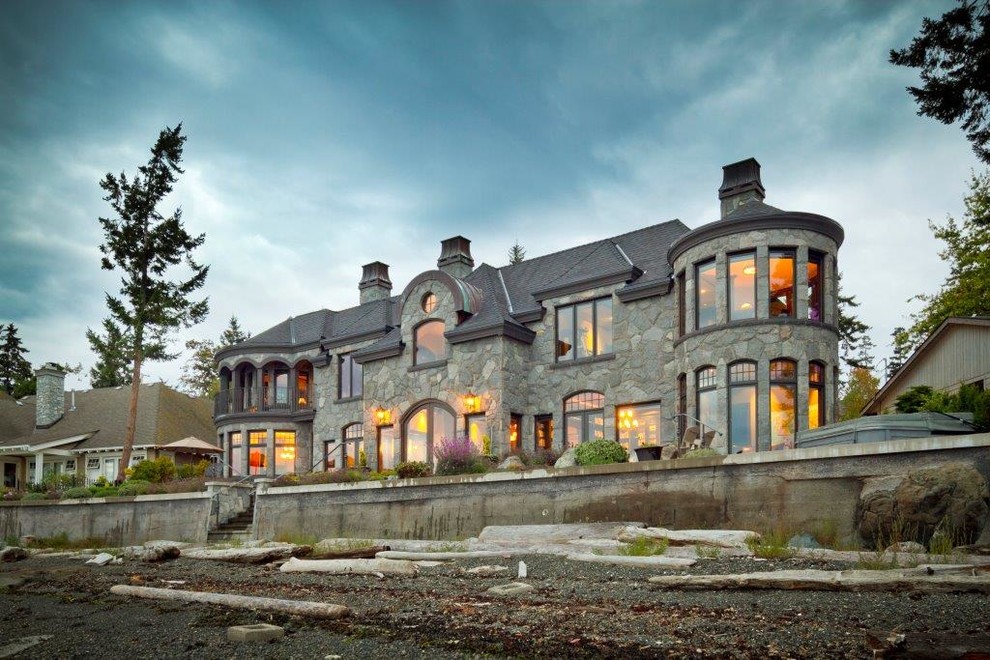 Inspiration for an expansive and gey victorian two floor house exterior in Vancouver with stone cladding and a pitched roof.