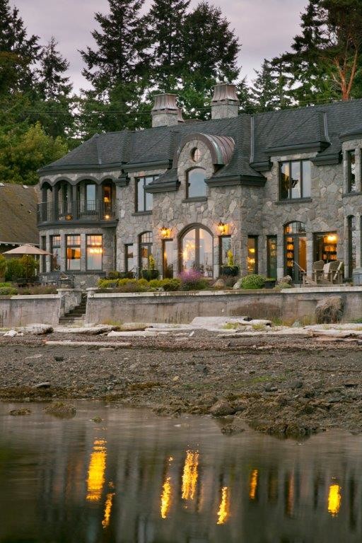 This is an example of an expansive and gey victorian two floor house exterior in Vancouver with stone cladding and a pitched roof.