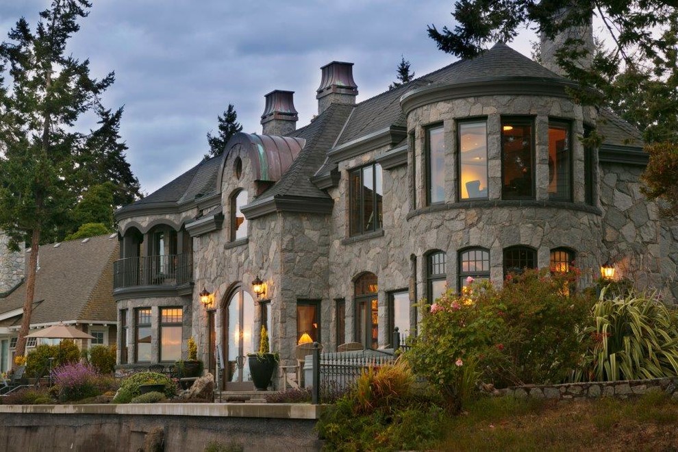 Inspiration for a huge victorian gray two-story stone gable roof remodel in Vancouver