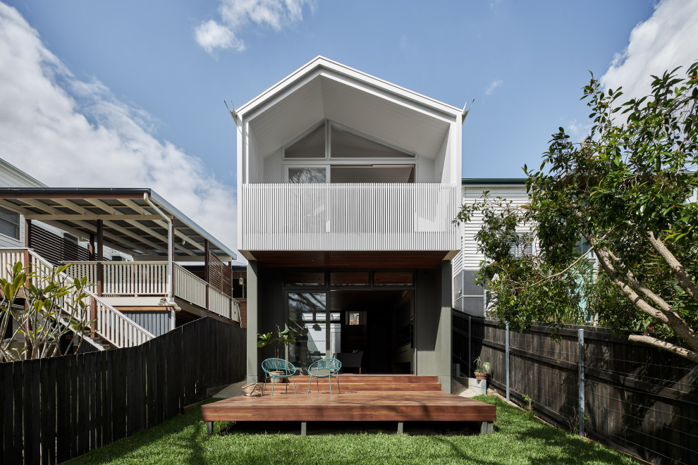 This is an example of a white contemporary bungalow detached house in Brisbane with a pitched roof.
