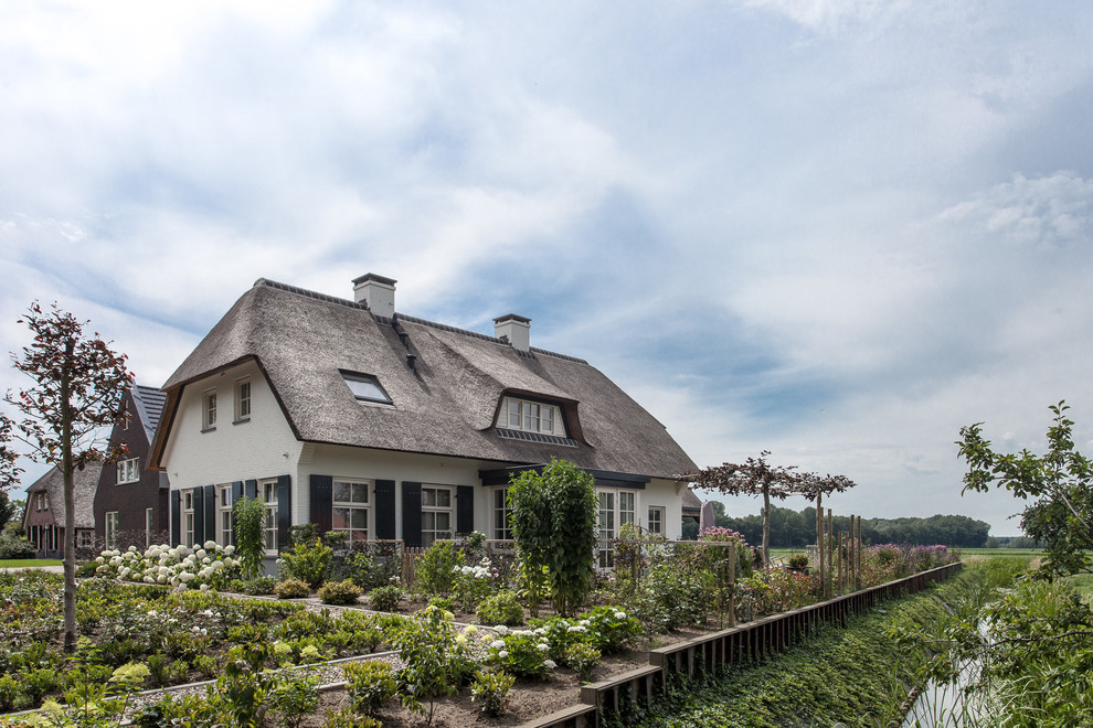 Photo of a white rural two floor detached house in Amsterdam.