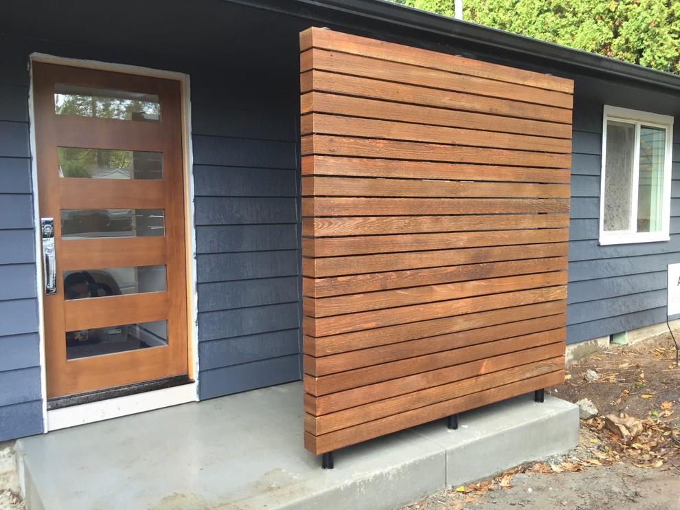 Inspiration for a mid-century modern blue one-story exterior home remodel in Portland