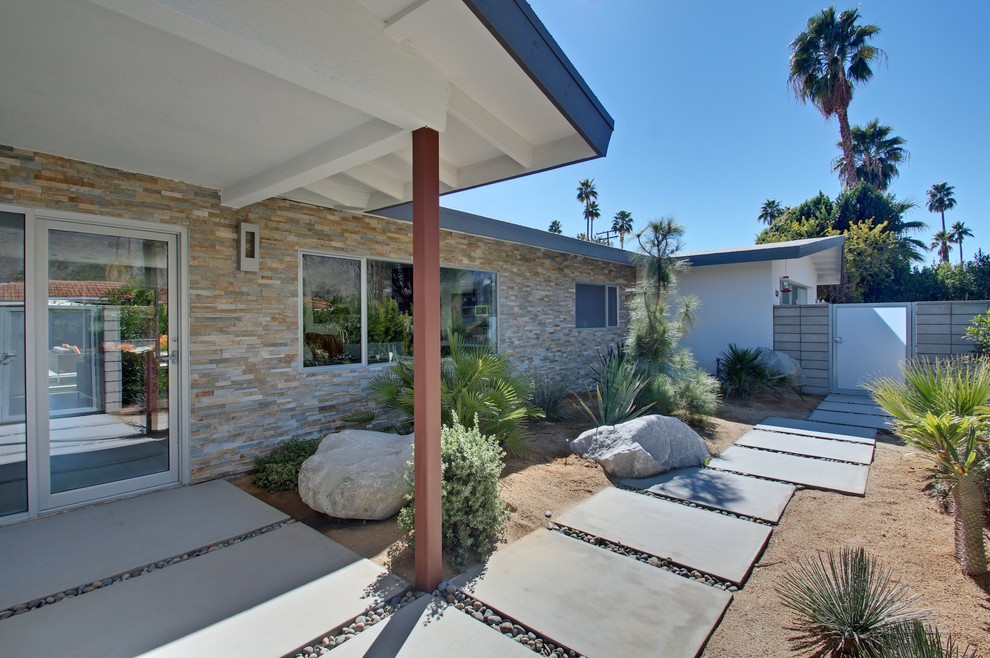This is an example of a medium sized and white midcentury bungalow house exterior in Los Angeles with mixed cladding.
