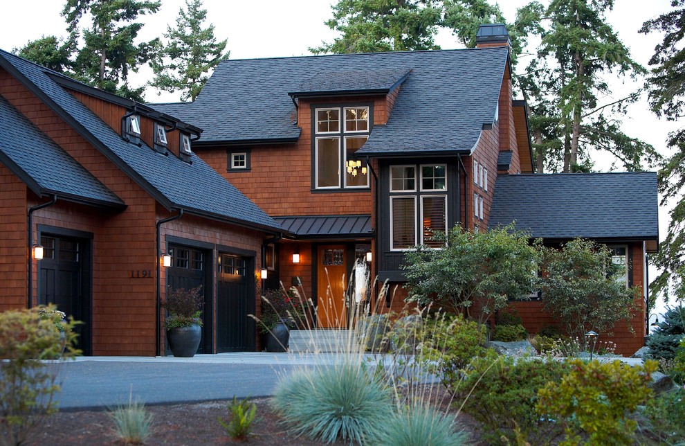 Photo of a black rustic house exterior in Seattle with three floors and wood cladding.