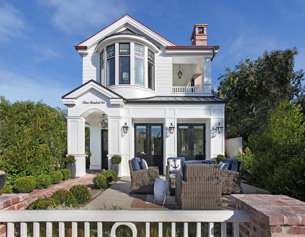 This is an example of a white classic two floor house exterior in Orange County.