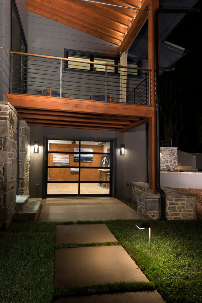 Kleines, Zweistöckiges Modernes Einfamilienhaus mit Mix-Fassade, grauer Fassadenfarbe und Pultdach in Sonstige