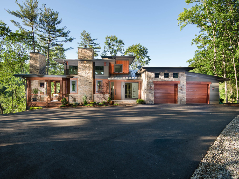 Inspiration for a large rustic multicolored three-story mixed siding house exterior remodel in Other with a shed roof and a metal roof