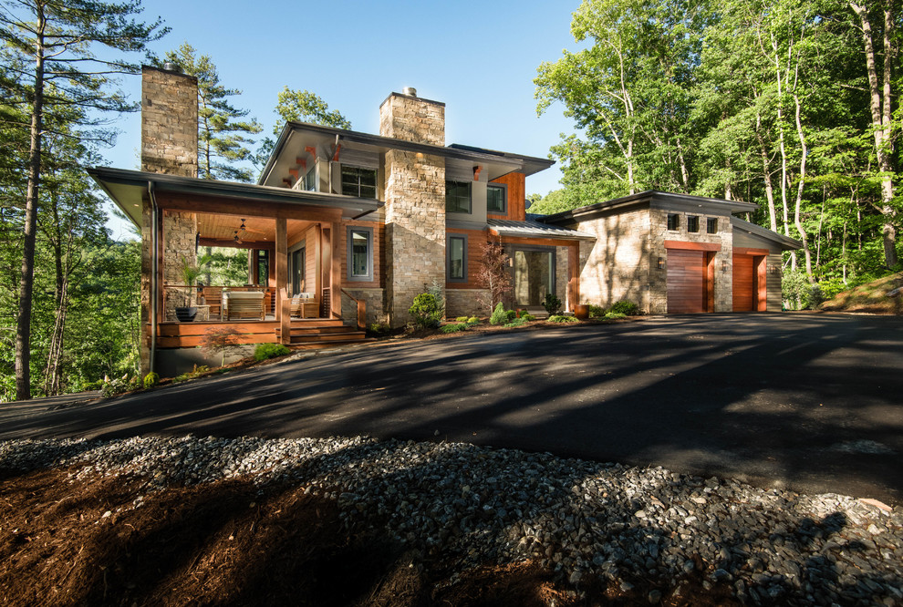 Example of a large mountain style multicolored three-story mixed siding house exterior design in Other with a shed roof and a metal roof
