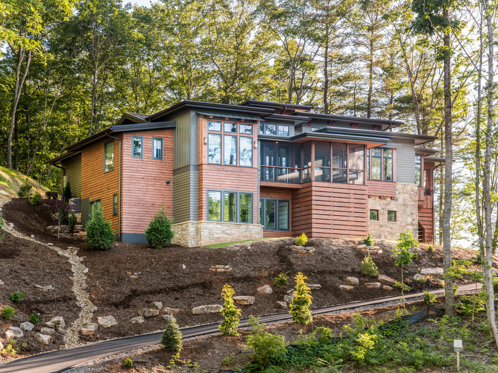 Example of a large mountain style multicolored three-story mixed siding house exterior design in Other