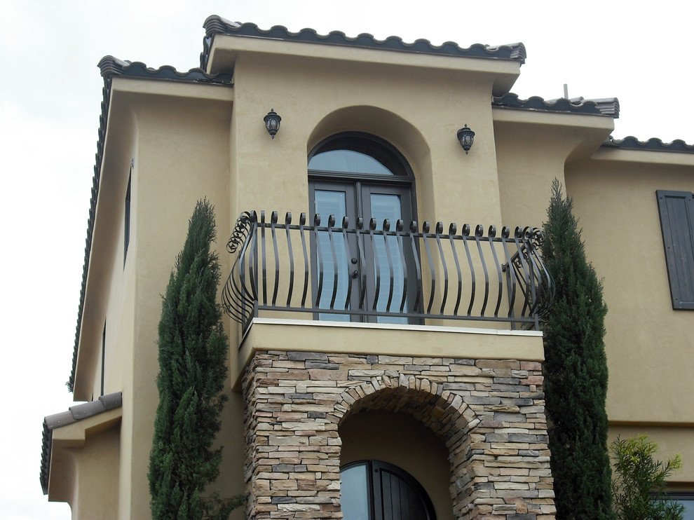 Photo of a small and yellow two floor house exterior in Salt Lake City with stone cladding.