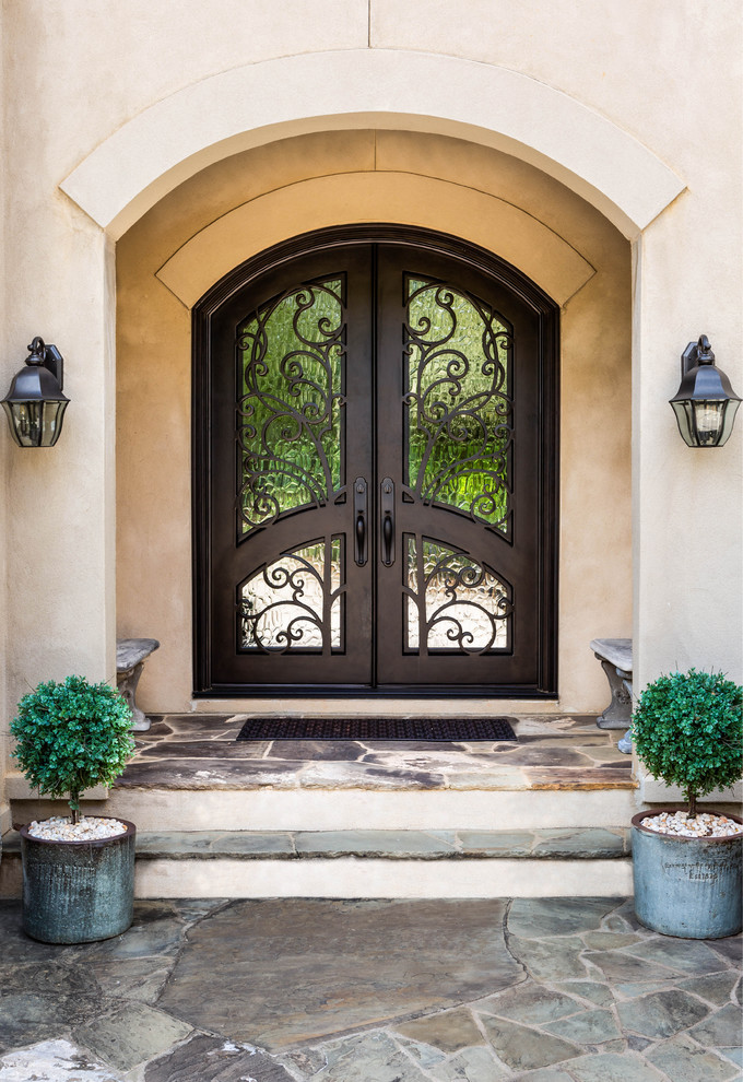 Inspiration for a large french country entryway remodel in Charlotte with a brown front door