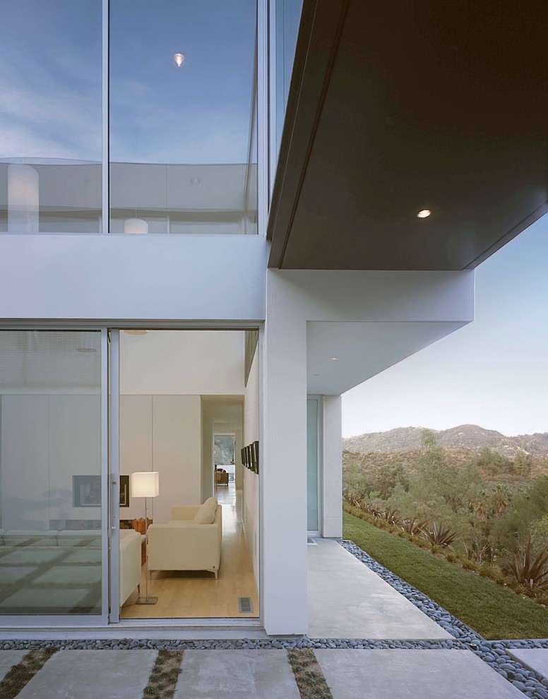 Свежая идея для дизайна: огромный, двухэтажный, белый дом в современном стиле с облицовкой из бетона и плоской крышей - отличное фото интерьера