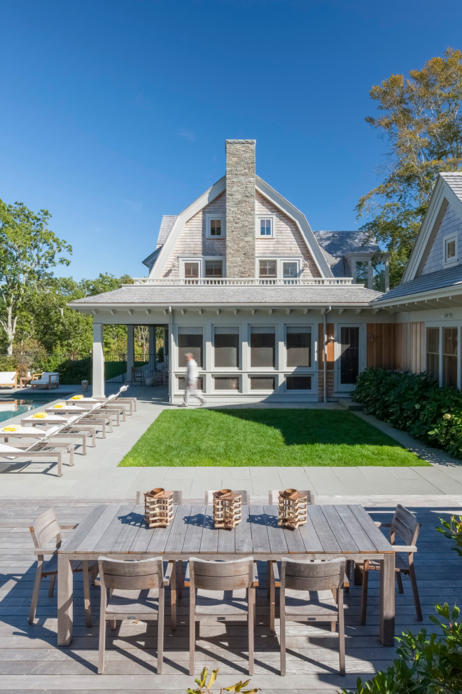 Inspiration for a coastal beige two-story wood house exterior remodel in Boston with a gambrel roof and a shingle roof