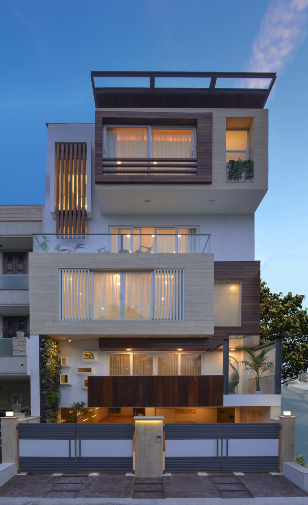 Design ideas for a large contemporary house exterior in Delhi with three floors.