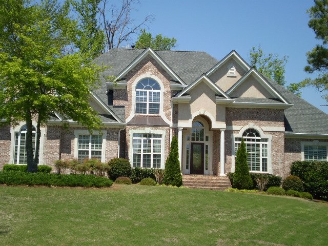 Photo of a large and beige traditional two floor brick house exterior in Atlanta.