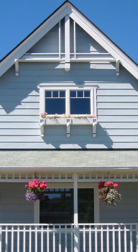 Photo of a blue country two floor house exterior in Seattle with wood cladding.